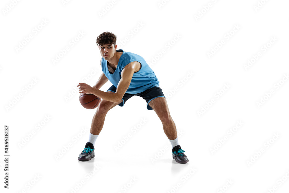 Dynamic portrait of basketball player practicing isolated on white studio background. Sport, motion, activity, movement concepts.