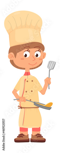 Boy frying pancakes. Chef kid with fry pan and slotted turner