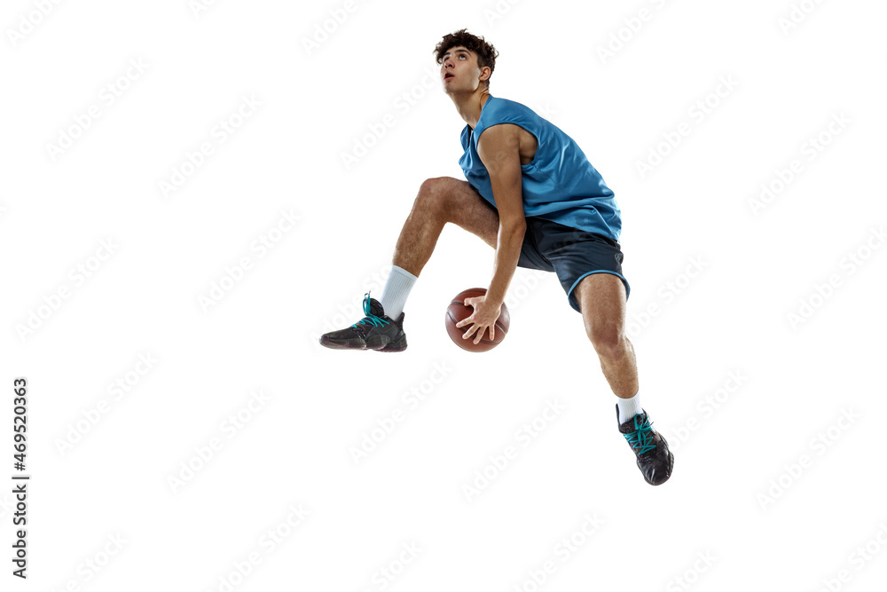 One professional basketball player in blue sports uniform training with ball isolated on white studio background.