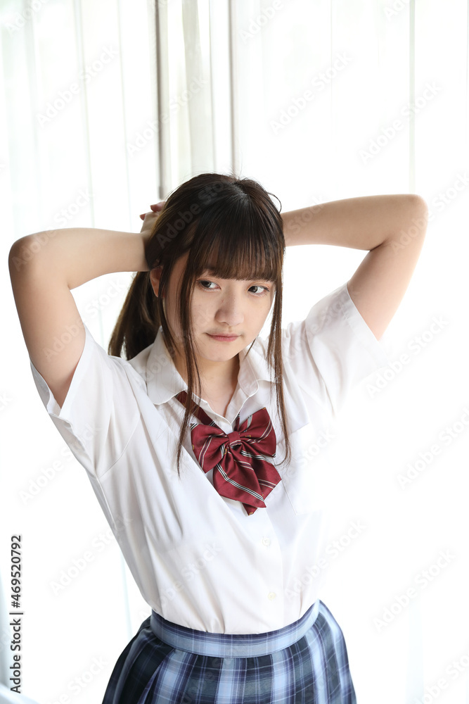 Portrait japanese school girl uniform in white tone bed room Portrait japanese school girl uniform in white tone bed room