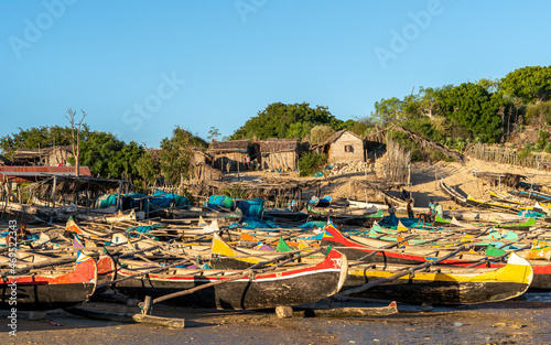 Colorful fishing boats docked along the shore in Madagascar, a lively representation of local craftsmanship and maritime culture.