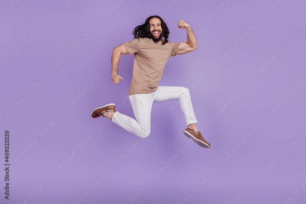 Full body profile side photo of young cheerful man sporty biceps training jump isolated on purple color background