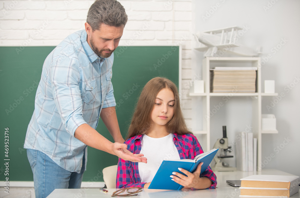 father and teen girl study. private teacher and child hold copybook. family help. father and teen girl study. private teacher and child hold copybook. family help.