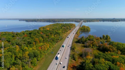 4K camera aerial drone view of Trans-Canada highway and fall season foliage colors in the outskirts of Montreal. Vertical climb down. photo