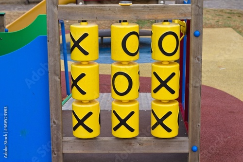 A plastic and wooden tic-tac-toe game in a children's playground in a public park (Umbria, Italy, Europe)