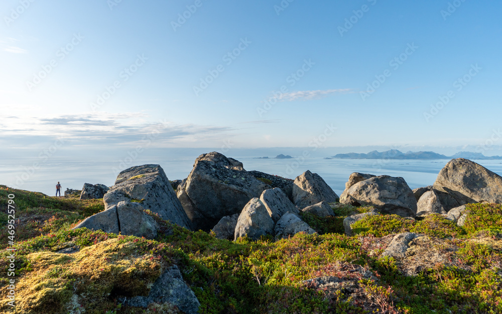 The rugged rocky shores of Lofoten stretch under the vast open skies, capturing the untamed essence of Norway's coastal beauty