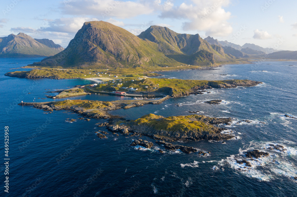 The panoramic view of Lofoten Archipelago in Norway reveals a stunning tapestry of scattered islands set against majestic mountain peaks