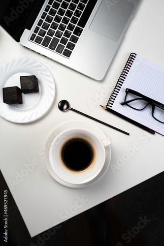 Workplace of a modern man with electronic devices and a cup of coffee on the desk.
