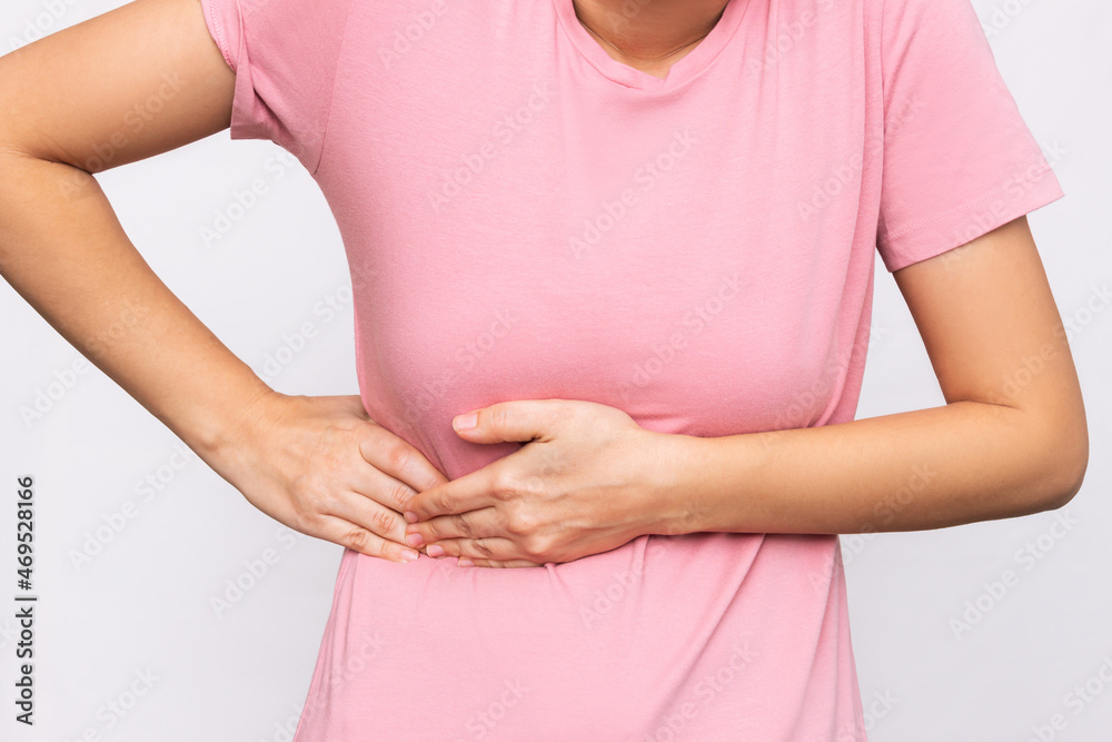 Young woman suffering from flank pain on white background Stock Photo