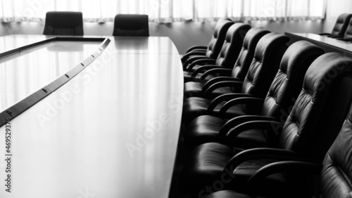 Conference table and chairs in modern meeting room photo