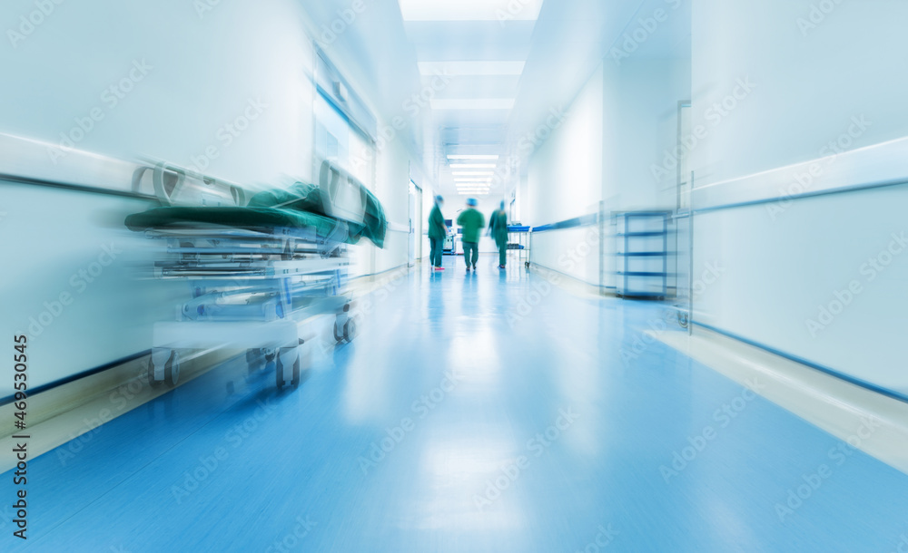Doctors or nurses walking in hospital hallway, blurred motion