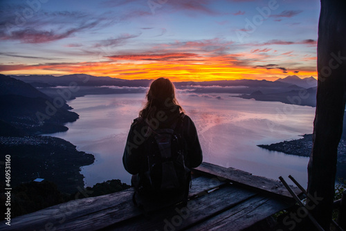 Tourist enjoying the sunrise from La Rostra Maya, Lake Atitlan, Guatemala photo