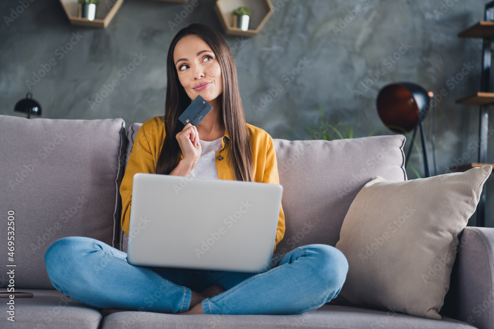 Photo of sweet pretty young lady dressed yellow shirt online shopping modern gadget smiling indoors room home house Photo of sweet pretty young lady dressed yellow shirt online shopping modern gadget smiling indoors room home house