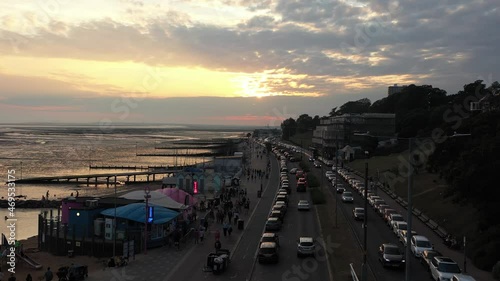 establishing shot of people having evening life at the beach in a town photo