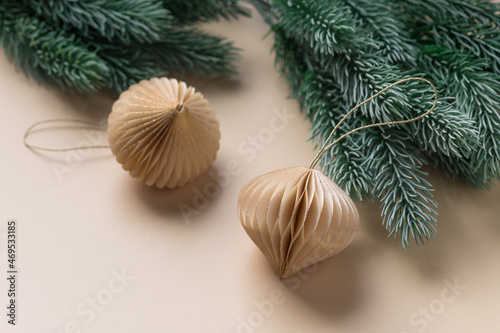 christmas composition with paper decorations and fir branches on beige background. copy space