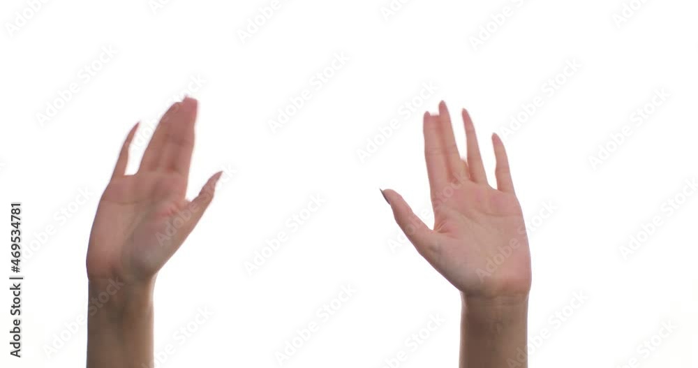 Close-up of a woman waving her hand and greeting someone, isolated, on a white background in a studio. Signs, symbols and gestures. Close-up of a woman waving her hand and greeting someone, isolated, on a white background in a studio. Signs, symbols and gestures.