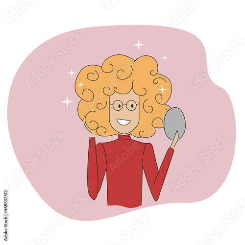 A girl with a beautiful hairstyle looks in the mirror.