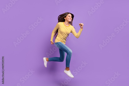 Full size profile side photo of youth lady run speed motion active look empty space isolated over violet color background