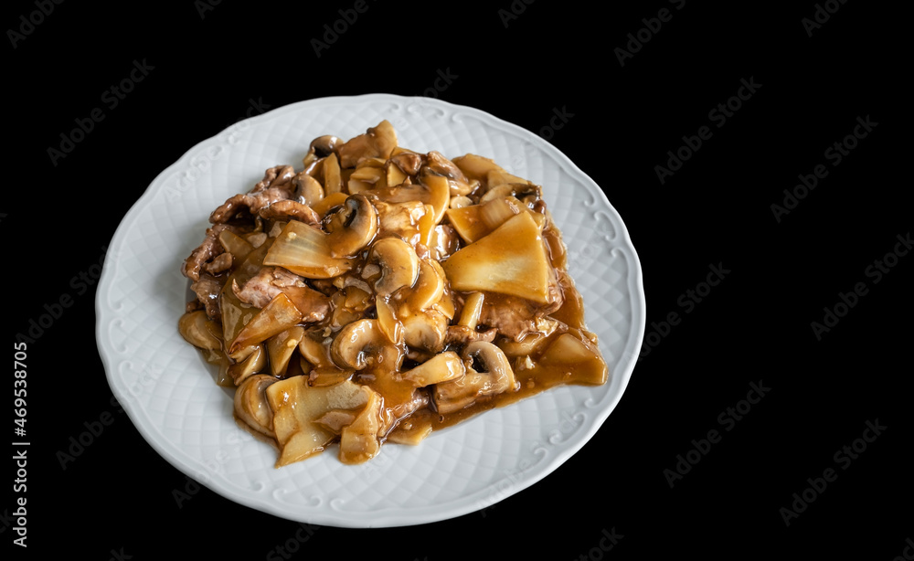 A traditional Chinese savory dish of cow stew and mushrooms in bamboo. On a black background, close-up. Copy space A traditional Chinese savory dish of cow stew and mushrooms in bamboo. On a black background, close-up. Copy space