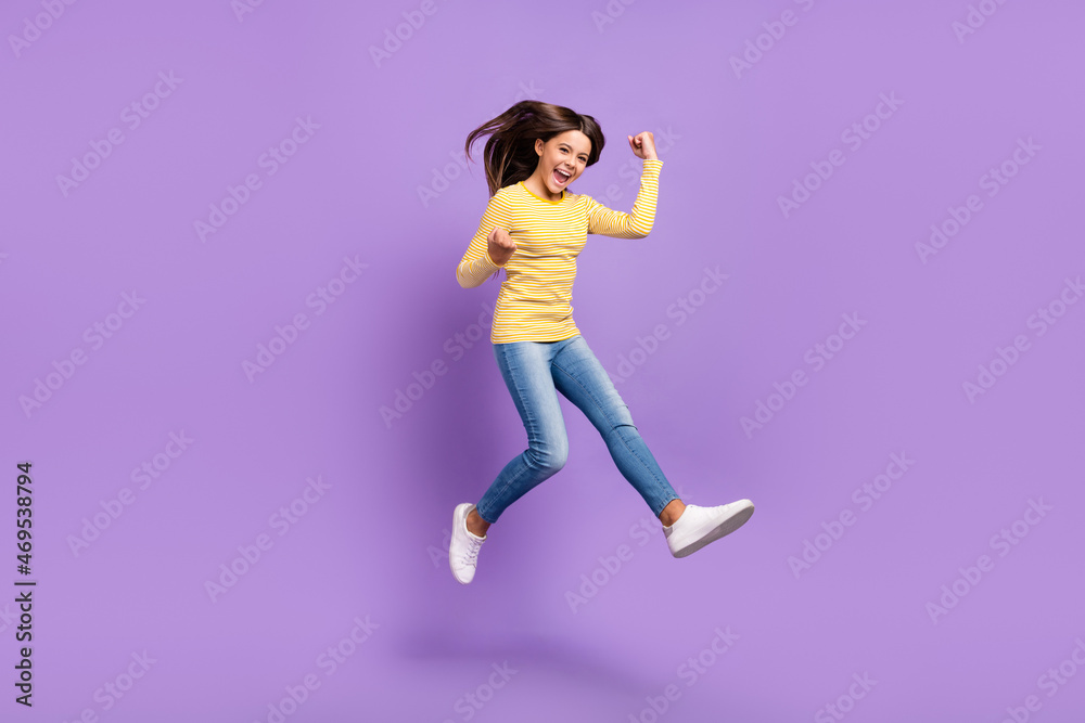 Full length photo of youth excited girl rejoice victory success awesome fists hands isolated over purple color background