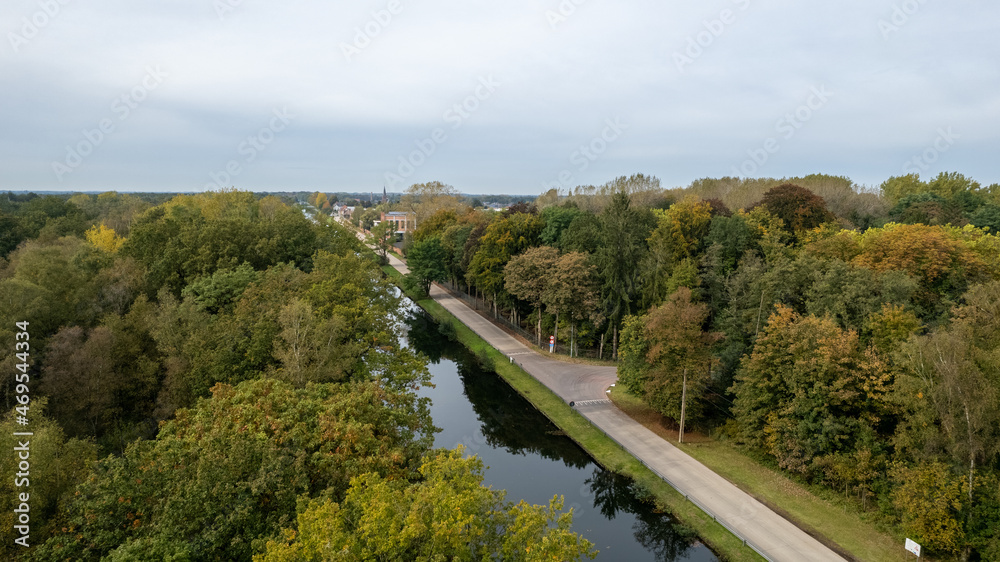 Aerial view the river on green forest plain. Amazing aerial shot of beautiful blue river. Forest background. High quality photo