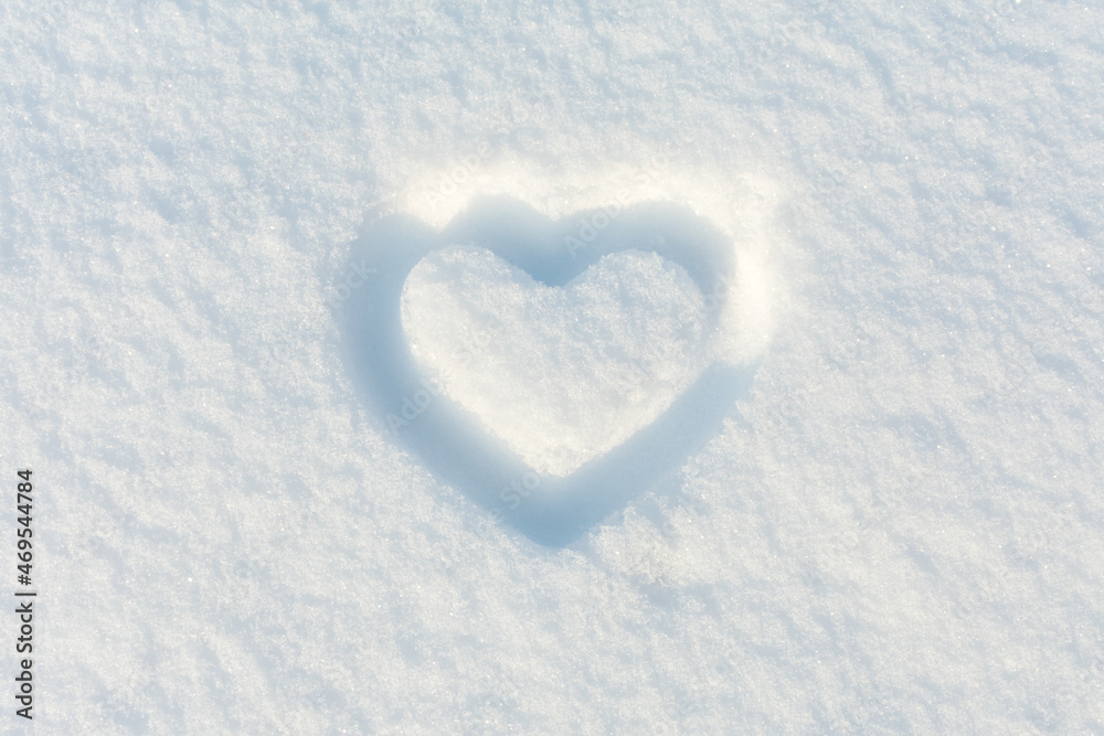 Heart on white snow. Place for an inscription. The basis for the postcard.