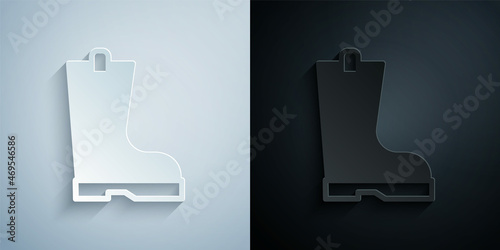 Paper cut Waterproof rubber boot icon isolated on grey and black background. Gumboots for rainy weather, fishing, gardening. Paper art style. Vector