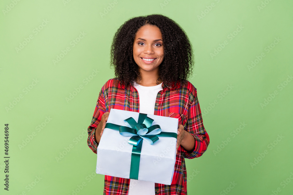 Photo of young charming african girl hold big present box event isolated over green color background