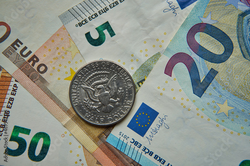 pół dolara na tle banknotów euro photo