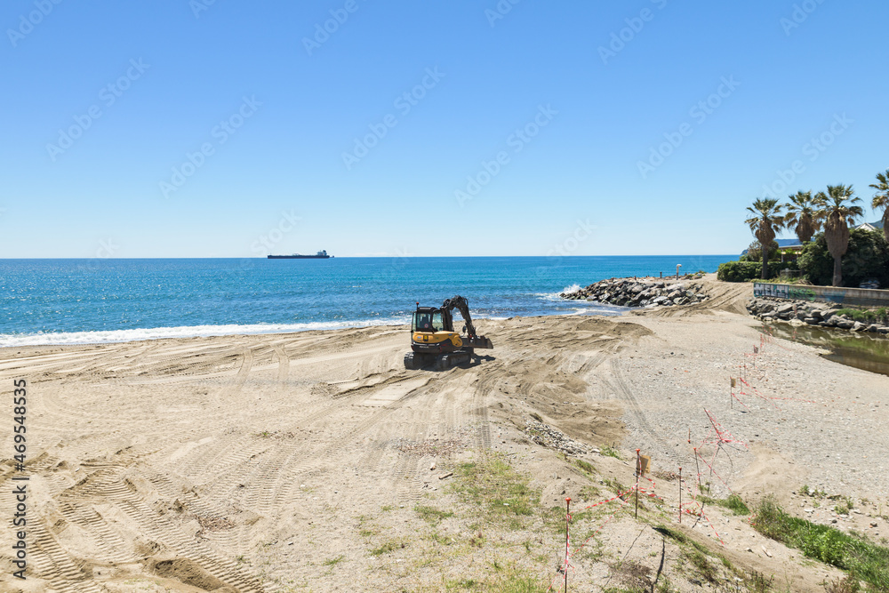 Savona, Italy. May 20, 2021. View of the free beach at the Walter Tobagi Promenade, where a bulldozer removes some debris.