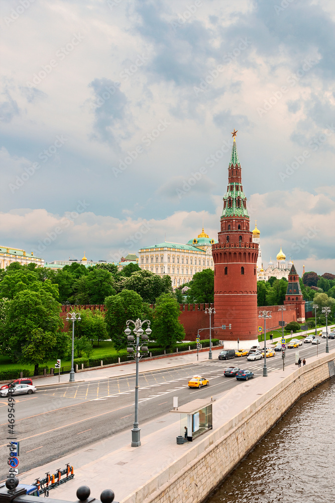 view from the bridge to the towers of the Moscow Kremlin and the Moskva River embankment against the background of a cloudy sky. Moscow. Russia