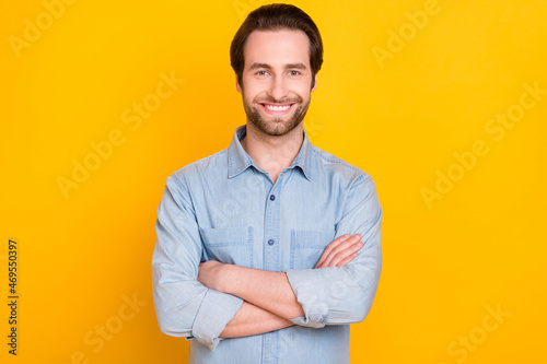 Photo portrait of young business man smiling happy folded hands isolated on vibrant yellow color background