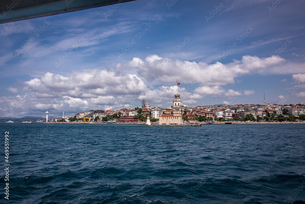 Maiden's Tower(Kiz Kulesi) also known as Leander's Tower view from a Bosphorus Ferry, Istanbul on a beautiful sunny day with white clouds and blue sky.