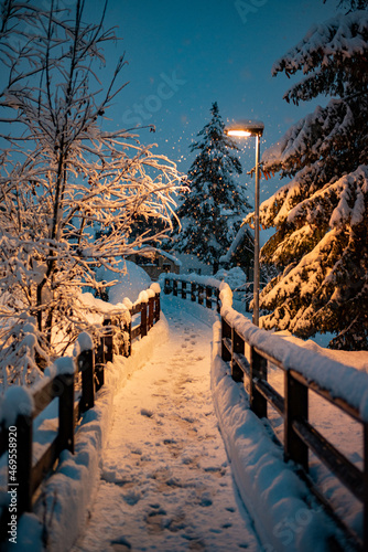 little city in winter forest on the mountains with snow and lights on backgrounds for christmas or new year promotion 