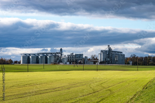 silver silos and modern granary elevator and seed cleaning line on agro-processing and manufacturing plant for storage and processing drying cleaning of agricultural products, flour, cereals, grain © hiv360