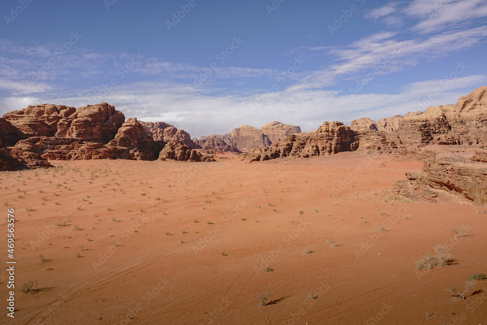 Fototapeta premium deserted valley in the Wadi Rum desert, car tire tracks in the sand, nature of Jordan