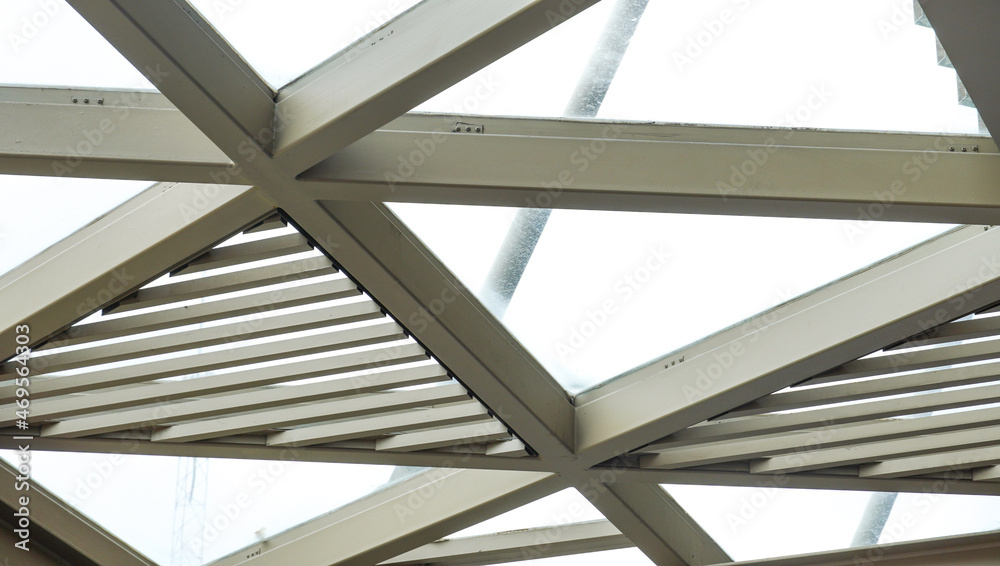the closeup view of the unique ceiling structure. the beautiful architectural design of the modern contemporary building. the transparent roof interior. the closeup view of the unique ceiling structure. the beautiful architectural design of the modern contemporary building. the transparent roof interior.