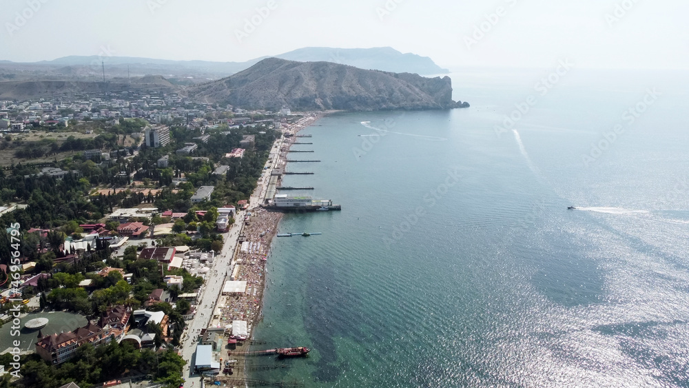 Flight over the embankment and the beach in Sudak.