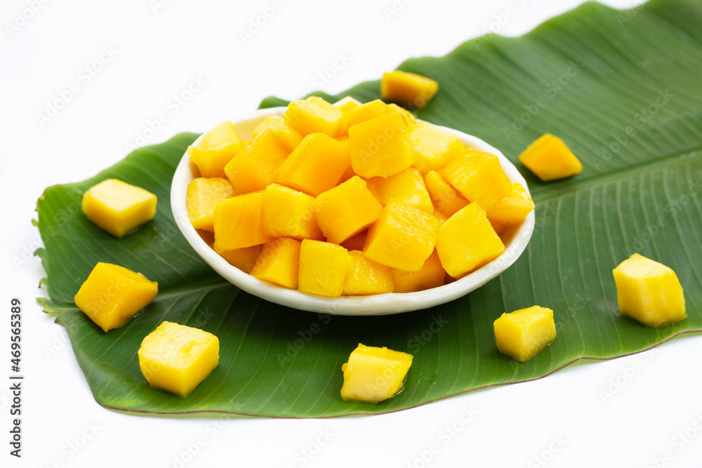 Tropical fruit, Mango cube slices in white bowl on banana leaf Tropical fruit, Mango cube slices in white bowl on banana leaf