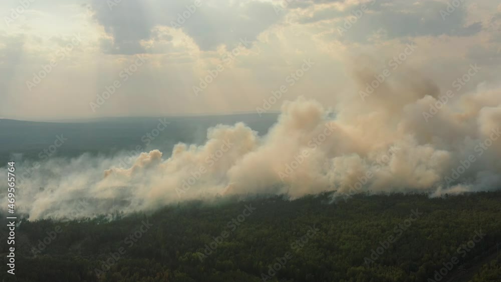 Big clouds of smoke over burning forest, aerial view from drone, wildfire in dry season. Large area of forest is on fire, natural disaster Big clouds of smoke over burning forest, aerial view from drone, wildfire in dry season. Large area of forest is on fire, natural disaster