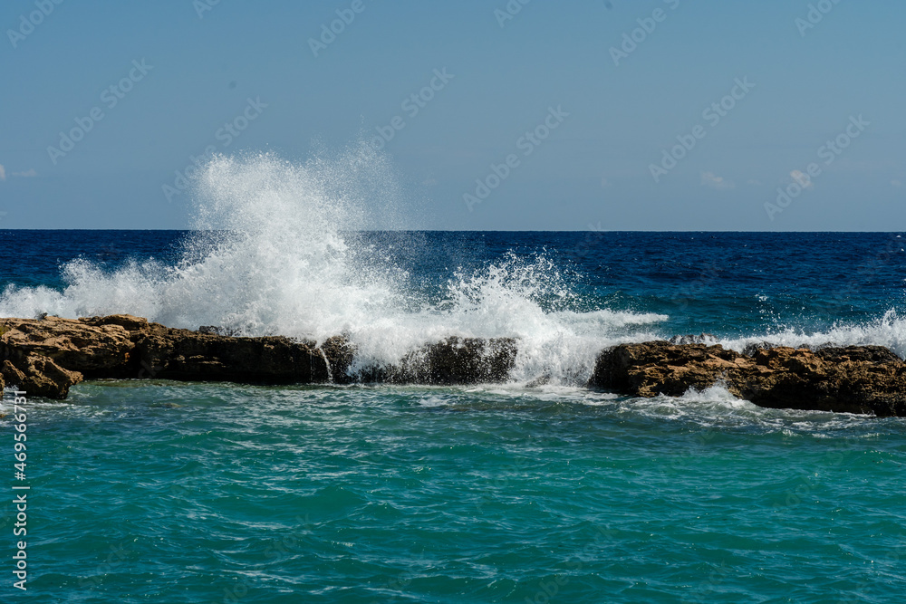Sea waves break at rock during storm Sea waves break at rock during storm