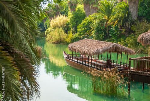 Tropical landscape. Lagoon with clear turquoise water rainforest and ancient boat made of wood.