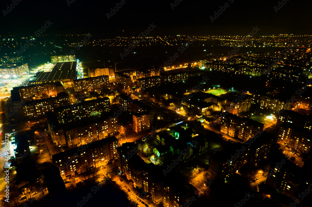 Amazing panoramic view of the evening city from above. Aerial view, night view of the city with night sky. Beautiful street lighting in the lanterns