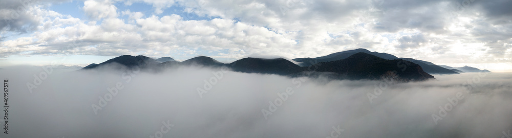Panoramic aerial view of a mountain in the fog, Tuscany, Italy
