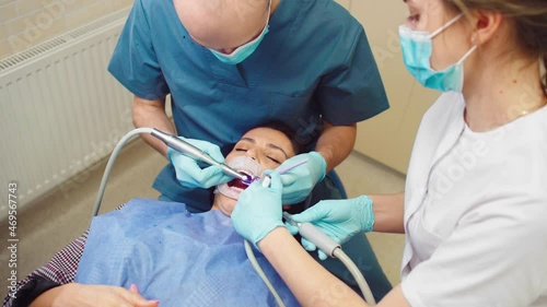 Closeup to the camera pretty woman make a oral examination at dentist , concept of oral care and teeth treatment