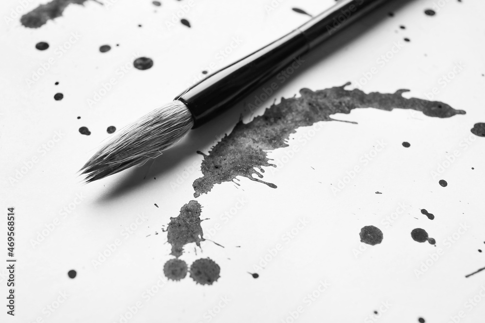 Ink spots and brush for calligraphy on white paper Ink spots and brush for calligraphy on white paper