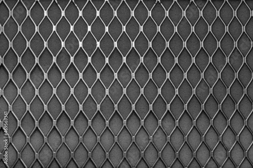 Metal grid with geometric pattern of rhombi, background. Black metallic modern background