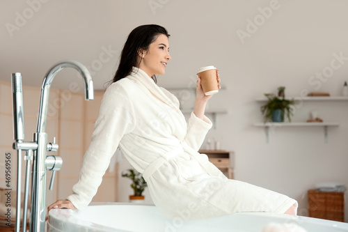 Pretty young woman with cup...