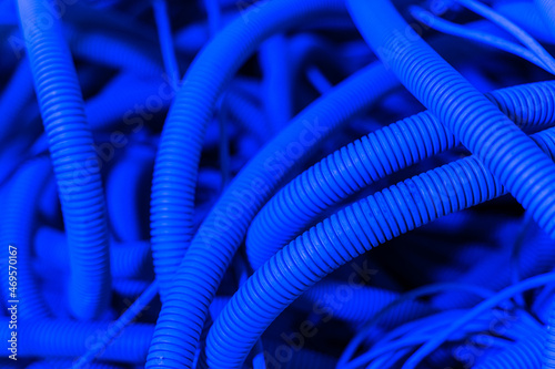A lot of tubes and cables in neon light. Air conditioning tube. Repair concept. Closeup photo