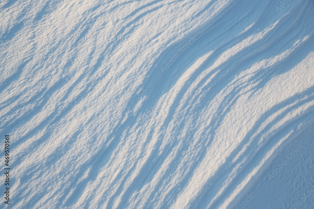 Beautiful winter background with snowy ground. Natural snow texture. Wind sculpted patterns on snow surface. Beautiful winter background with snowy ground. Natural snow texture. Wind sculpted patterns on snow surface.